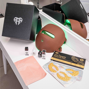 Cosmetic products including a brown mask, skincare items, and packaging on a white surface.